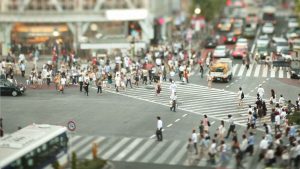 a flock of people crossing a street